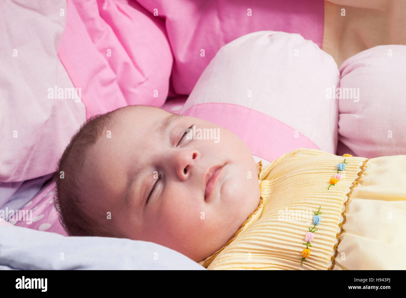 Baby girl sleeping in cot Stock Photo Alamy