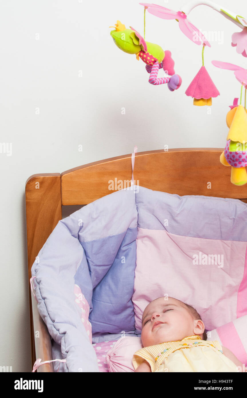 Baby girl sleeping in cot Stock Photo Alamy