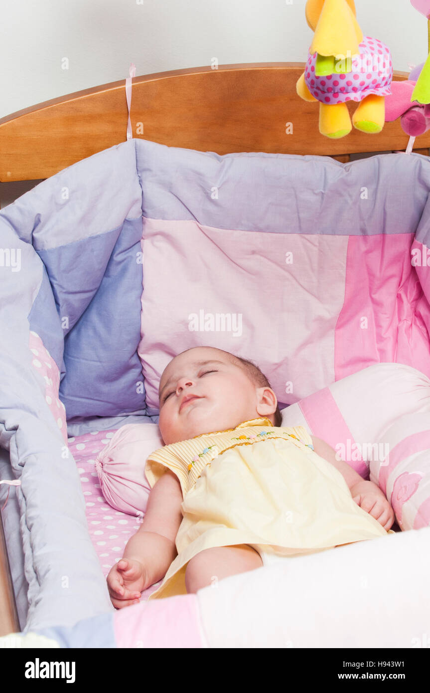 Baby girl sleeping in cot Stock Photo Alamy
