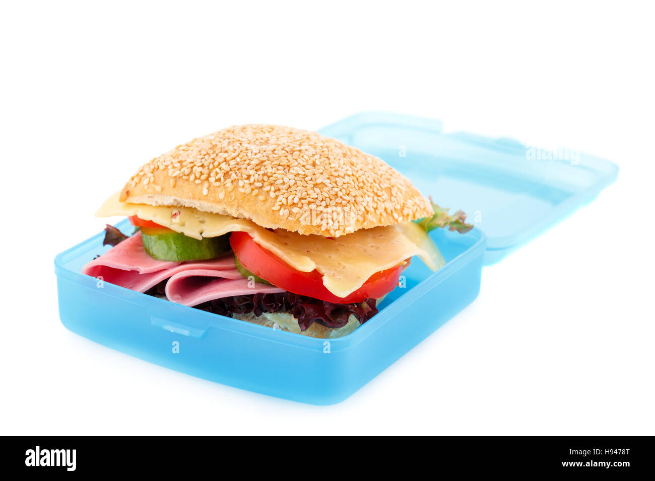 Sandwich with fresh vegetables, ham and cheese in plastic container isolated on white background. Stock Photo