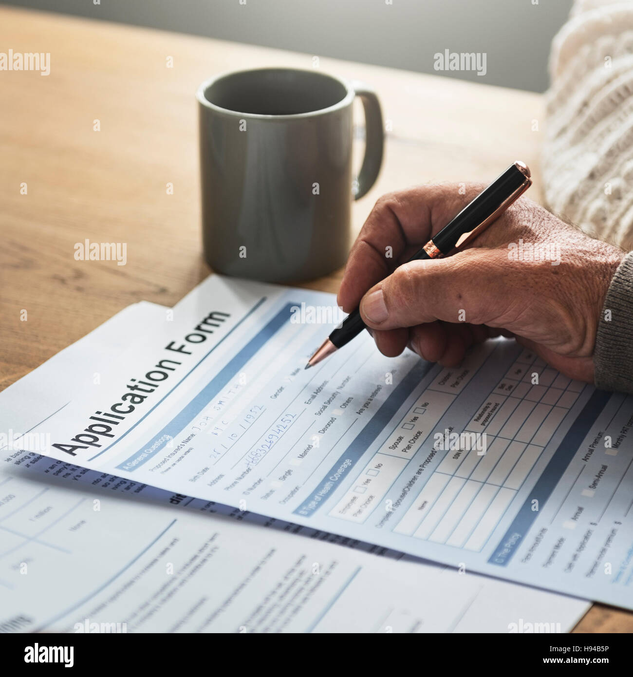 Senior Adult Writing Application Form Concept Stock Photo - Alamy