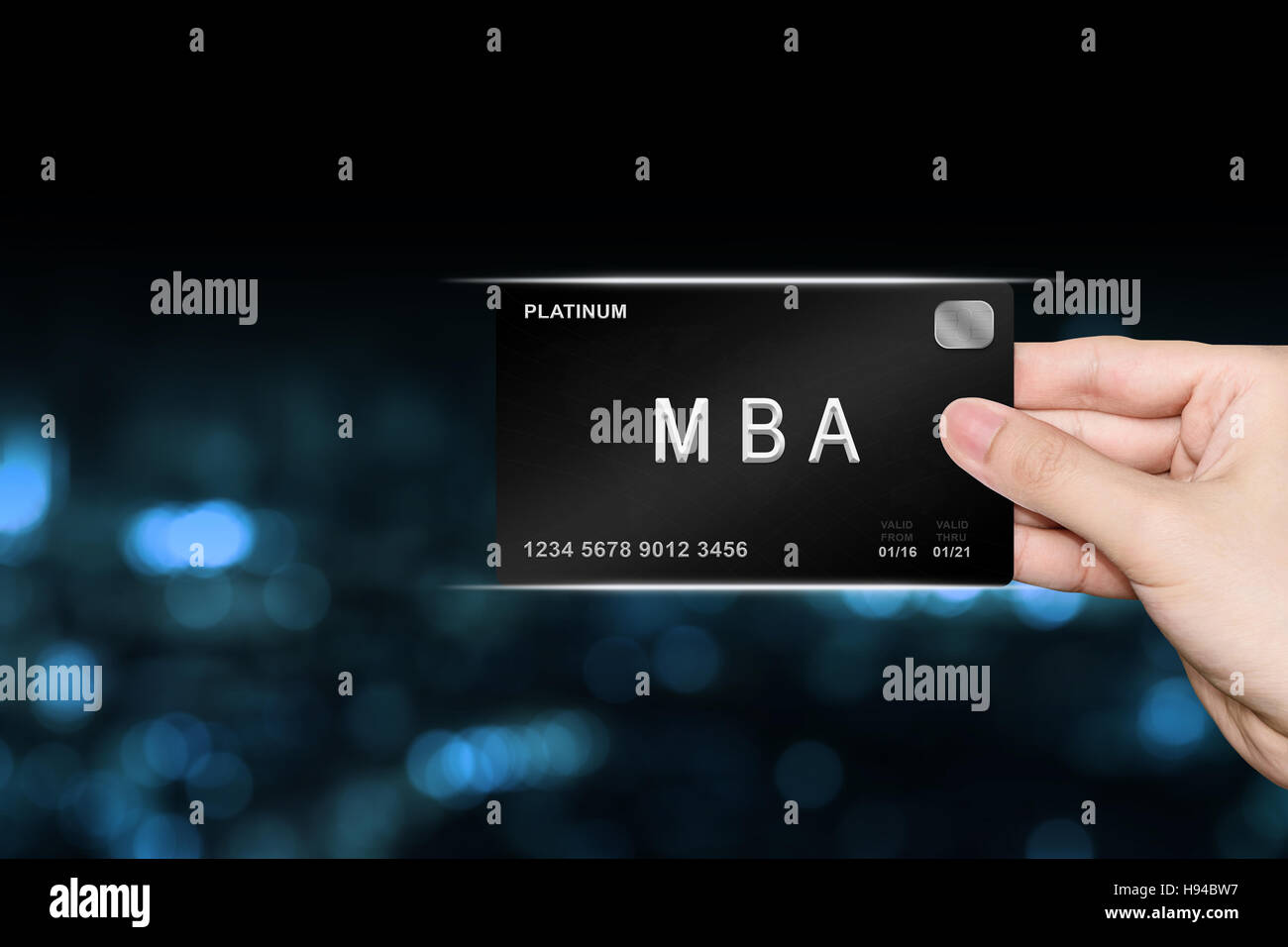 hand picking MBA or Master of Business Administration platinum card on blur background Stock Photo