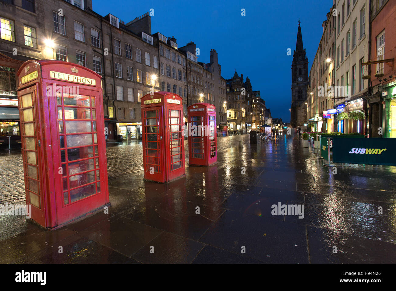 City of Edinburgh, Scotland. Picturesque night view of three K6 red telephone boxes on the Royal Mile. Stock Photo