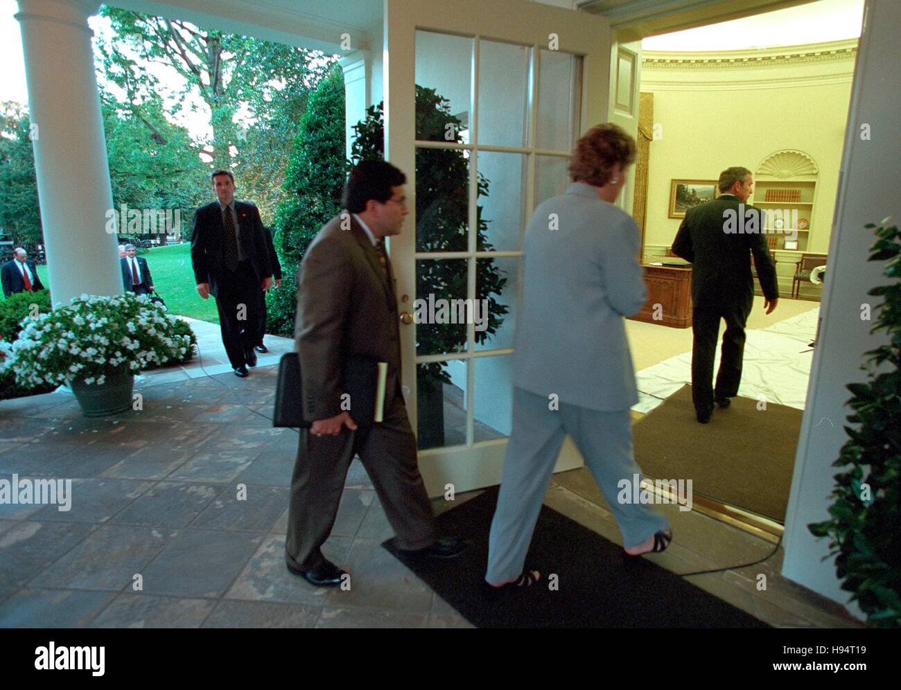 Presidential Counselors Karen Hughes and Alberto Gonzales follow U.S. President George W. Bush into the White House Oval Office upon his return September 11, 2001 in Washington, DC. Stock Photo