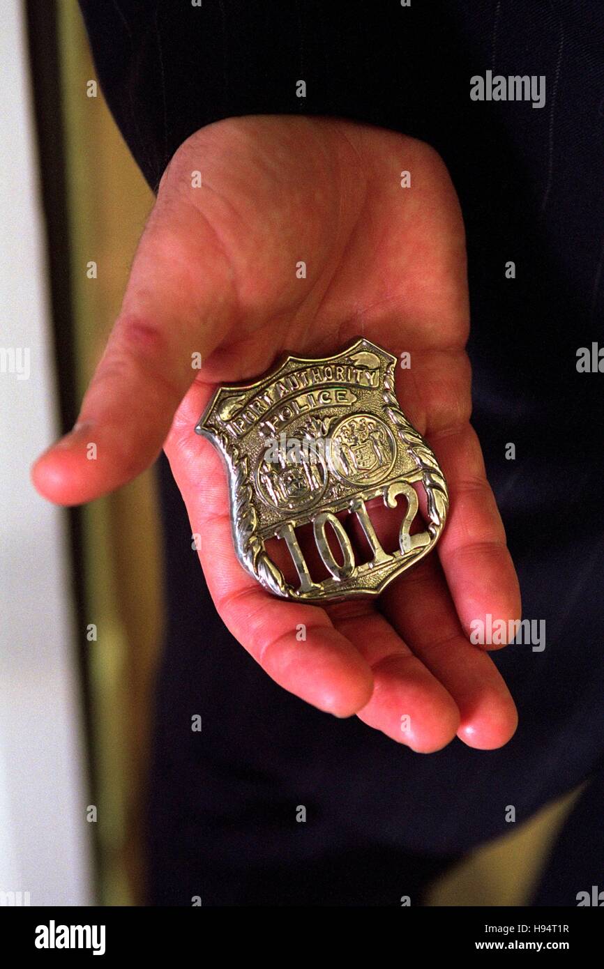U.S. President George W. Bush holds the badge of a police officer killed in the September 11 terrorist attacks at the White House October 15, 2001 in Washington, DC. Stock Photo