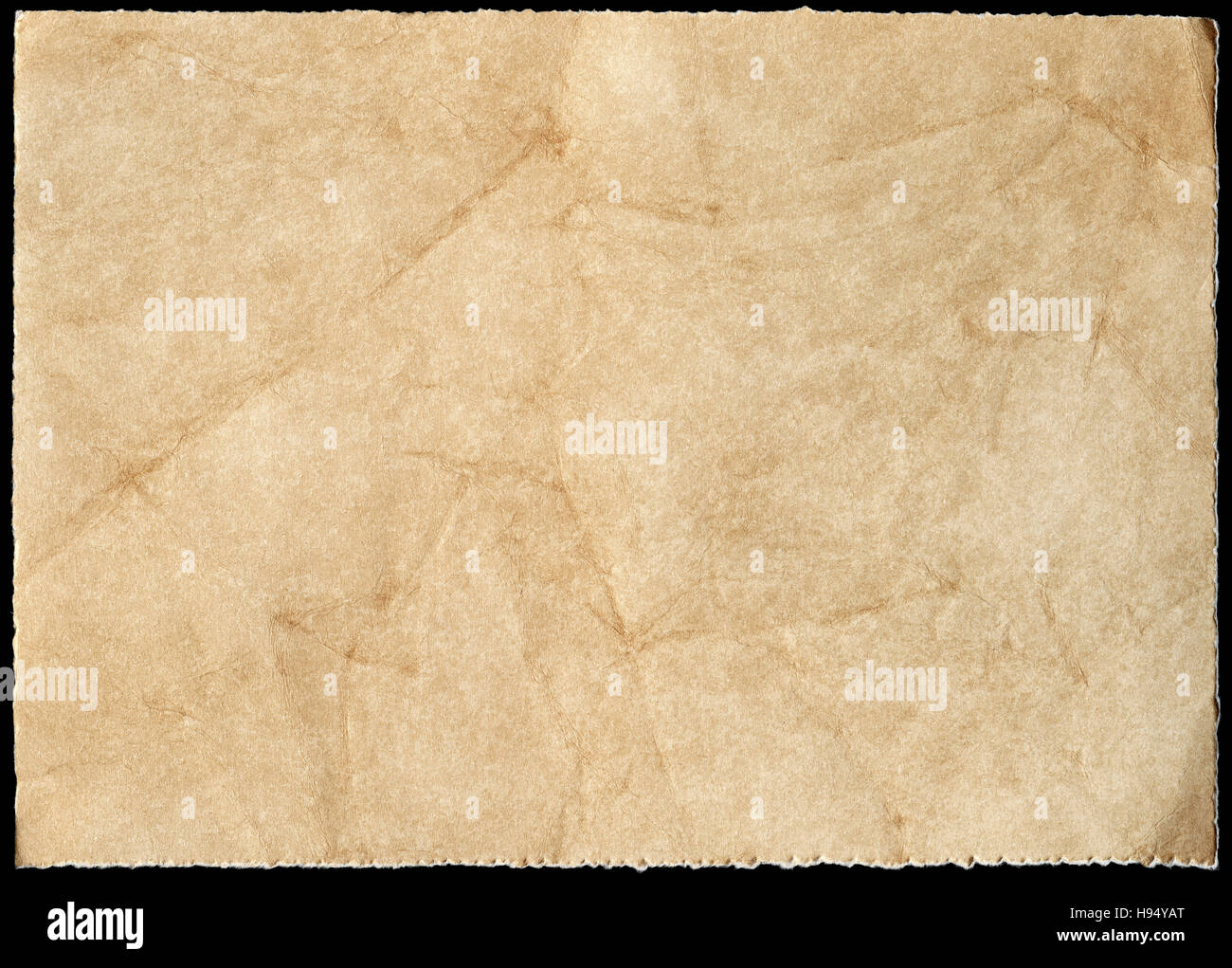 Old stained paper isolated on a black background. Stock Photo