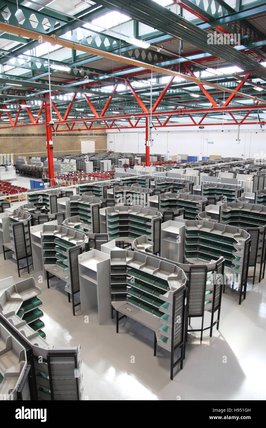 Interior of a new Post Office sorting office in Southern England, UK. Shows sorting desks ready for use Stock Photo