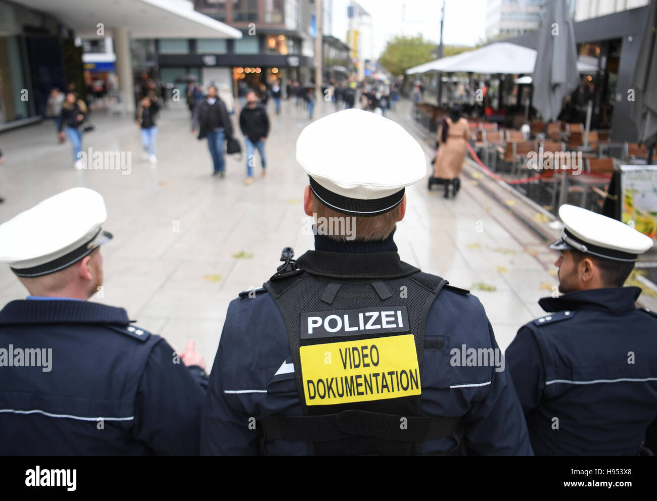 A police officer wearing a video camera on his shoulder (c) inbetween ...