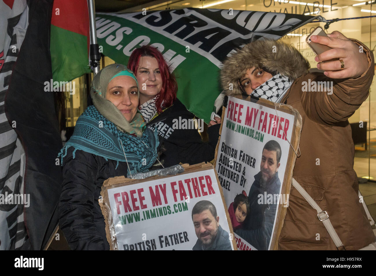 London, UK. 18th November 2016. Protesters take a slefie with Laila Sharary (left), wife of Fayez Shahary at the protest by human rights group Inminds outside the headquarters of British security company G4S over the abduction by Israel and subsequent torture of British national and father of five Fayez Sharary. Arrested by Israeli forces  on 15 September when leaving the West Bank for Jordan with his wife and youngest child to fly home after a family visit he was tortured for 3 weeks by Israeli secret police to force a confession An Israeli judge declared this worthless and inadmissible and o Stock Photo