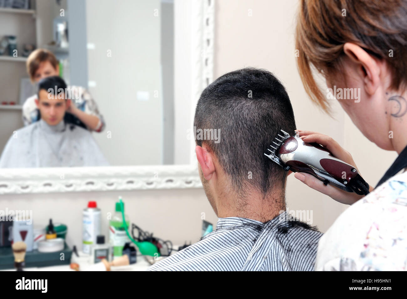 An Africanamerican Brazilian Barber Is Cutting With Scissors And Combing  The Hair Of The Head To A Caucasian Man With A Beard Hipster Style Vintage  Stock Photo - Download Image Now - iStock