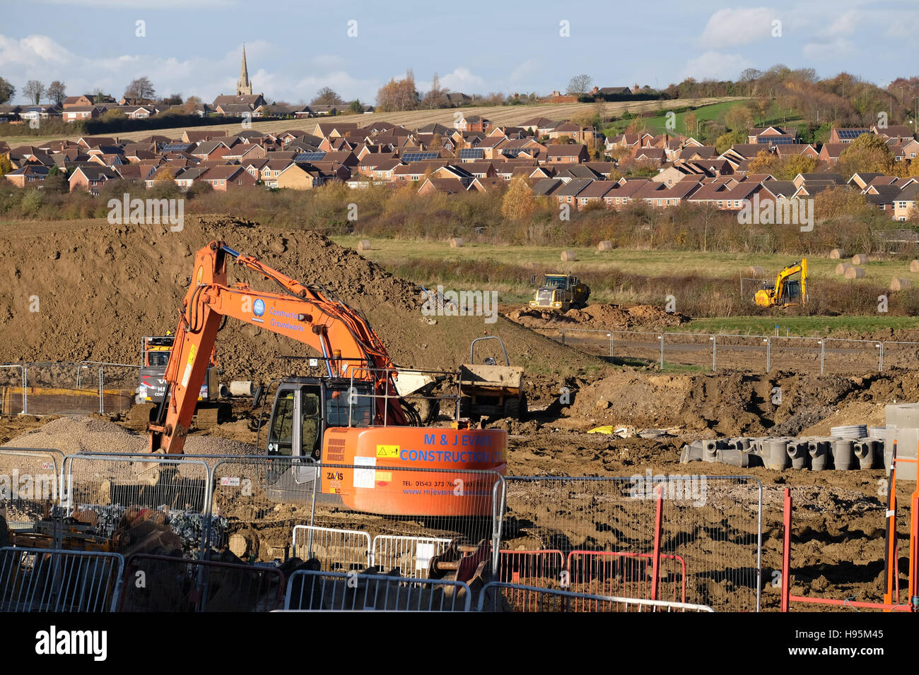 Heavy machinery being used to level the ground for house building, Grantham Lincs, England, UK Stock Photo