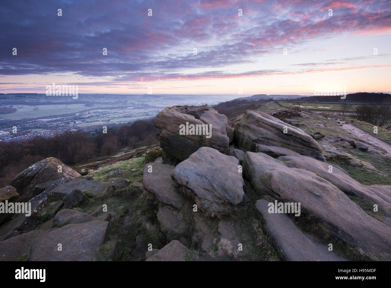 Dramatic sky at sunrise over the Wharfe Valley on a frosty, misty, winter morning - view from Otley Chevin, Yorkshire, England. Stock Photo