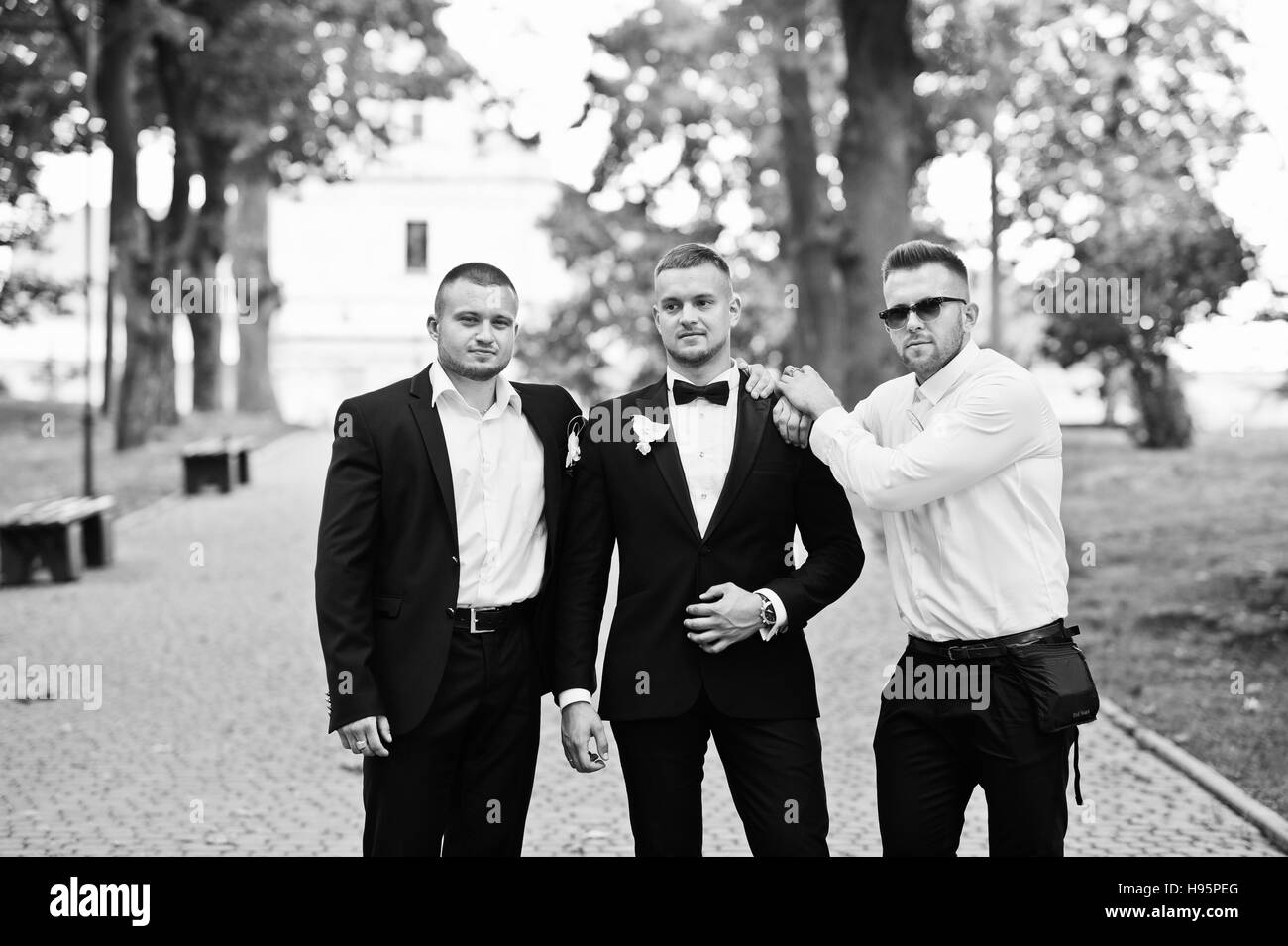 Personable Groom With Best Mans Or Groomsman Posed On Park At