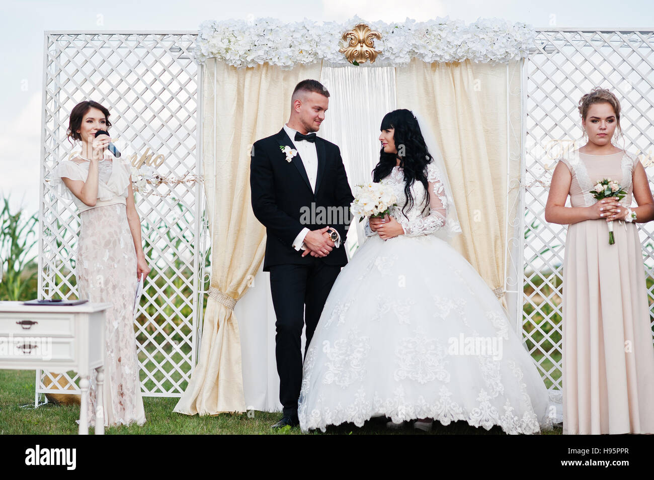 Amazing wedding ceremony with master of ceremonies, wedding couple and best mans with bridesmaids. Stock Photo