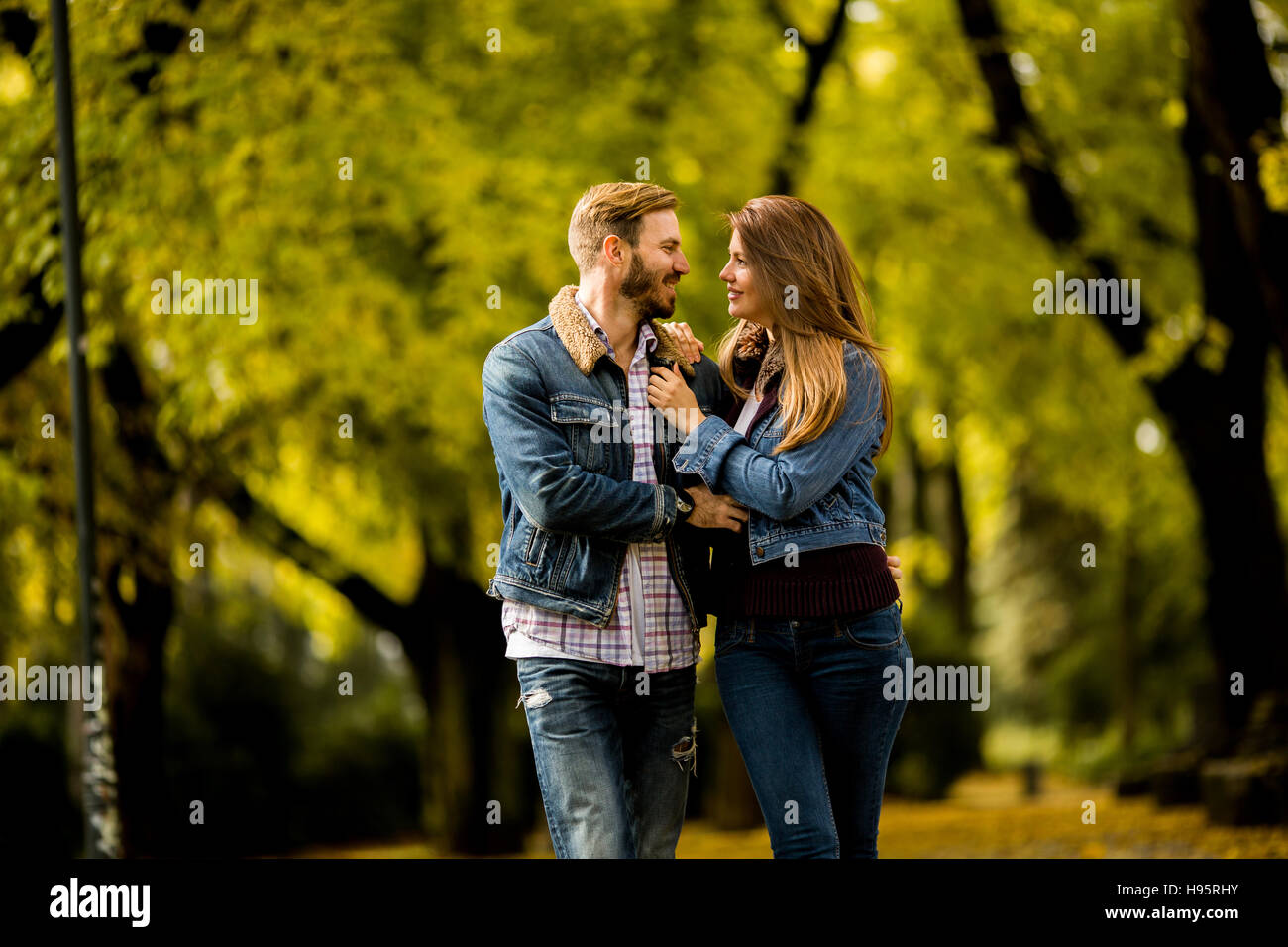 Young loving couple having a walk in the autumn park Stock Photo - Alamy