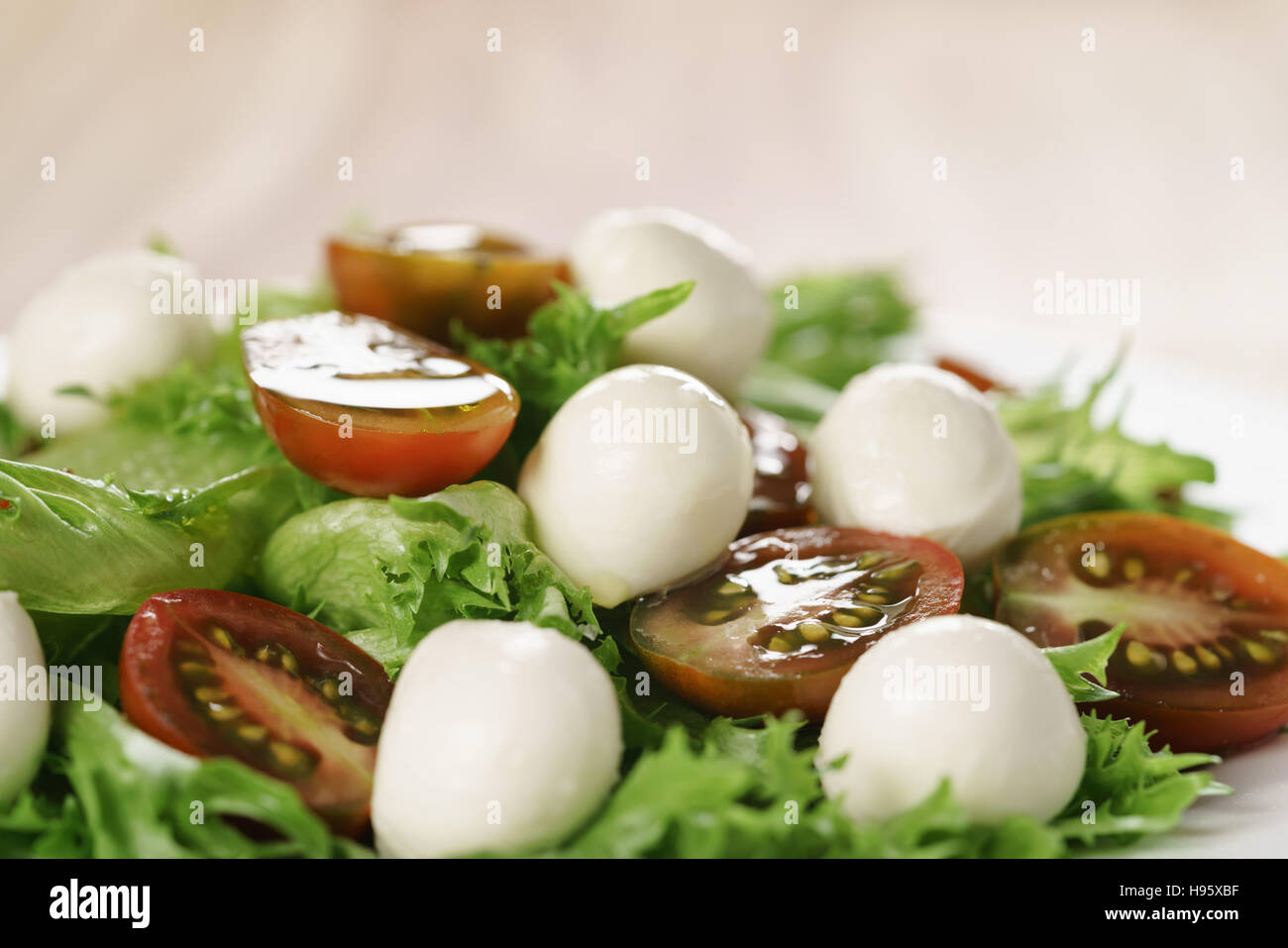 salad with kumato tomato, mozzarella and frillies lettuce Stock Photo