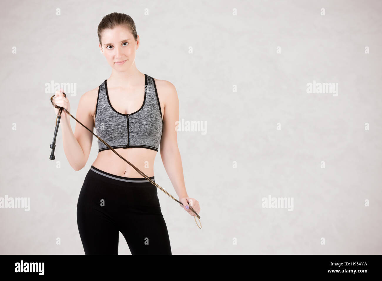 Back of sporty woman with a jumping rope, isolated Stock Photo