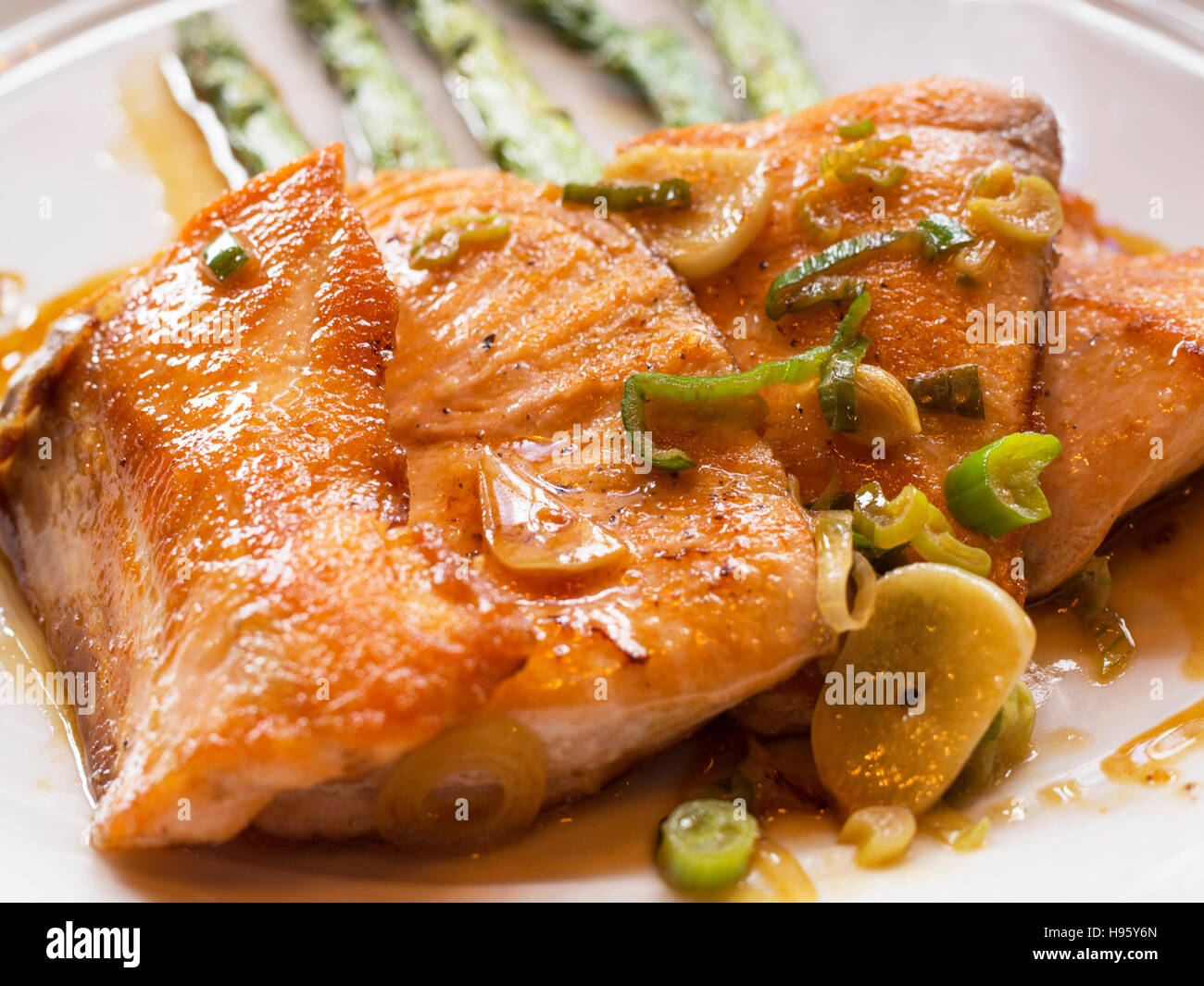 Loins grilled salmon served with asparagus and strips of green peppers Stock Photo