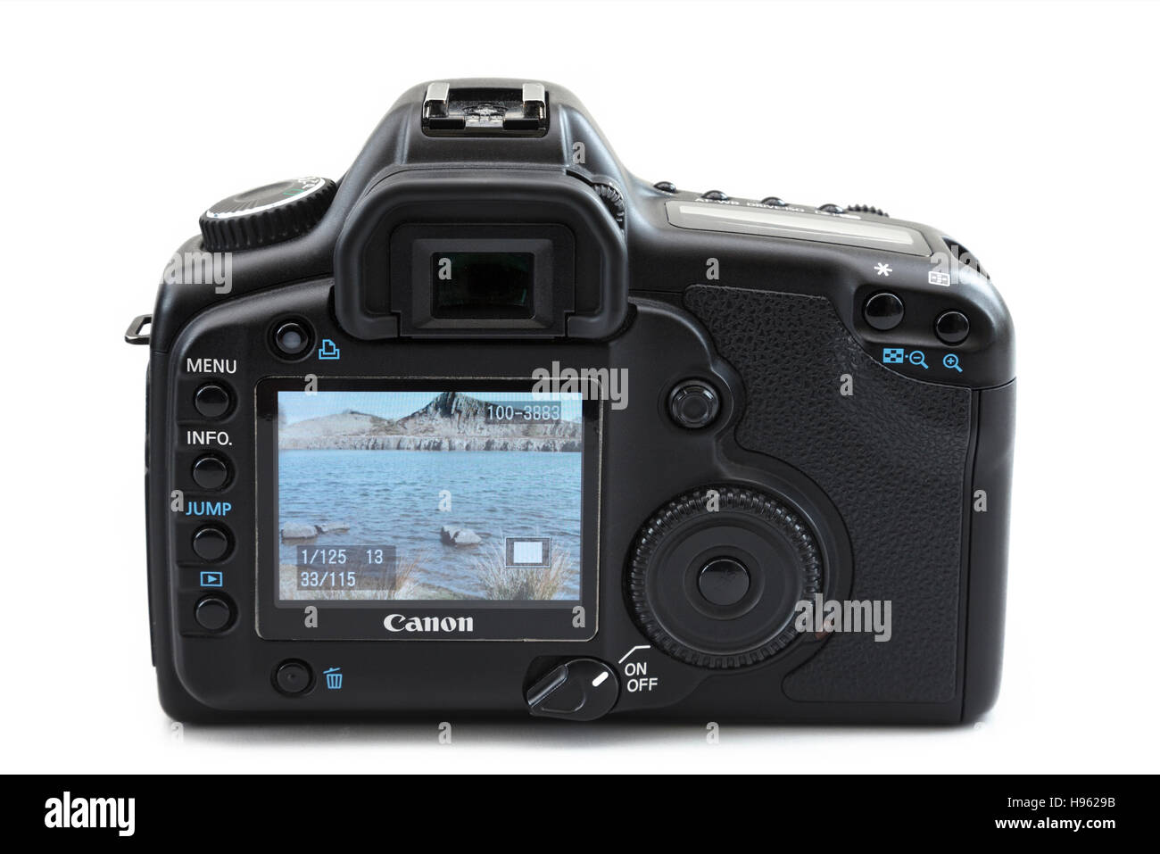 LCD screen on back of a Canon 5D mk II digital SLR camera showing a photograph of a coastal outdoor scene. Isolated on white Stock Photo