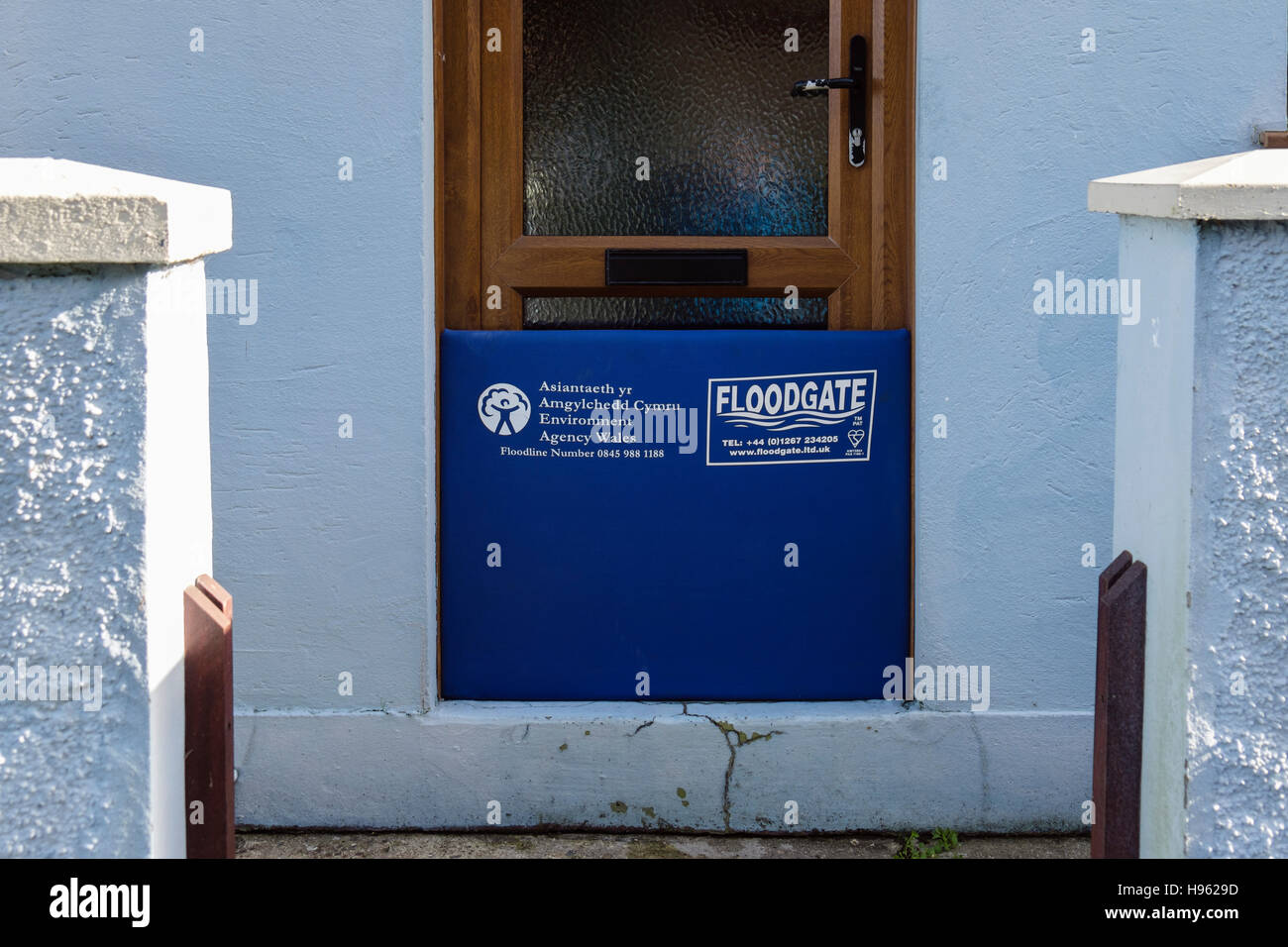 Environmental Agency Wales Floodgate across a front door in a house in Lower Fishguard, Pembrokeshire, Wales, UK, Britain Stock Photo