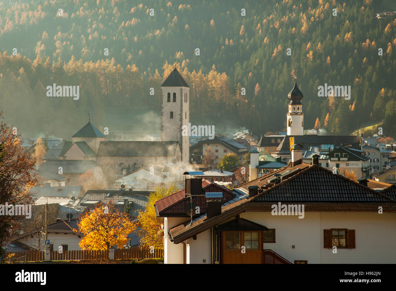 Misty autumn morning in San Candido (Innichen), South Tyrol, Italy. Stock Photo