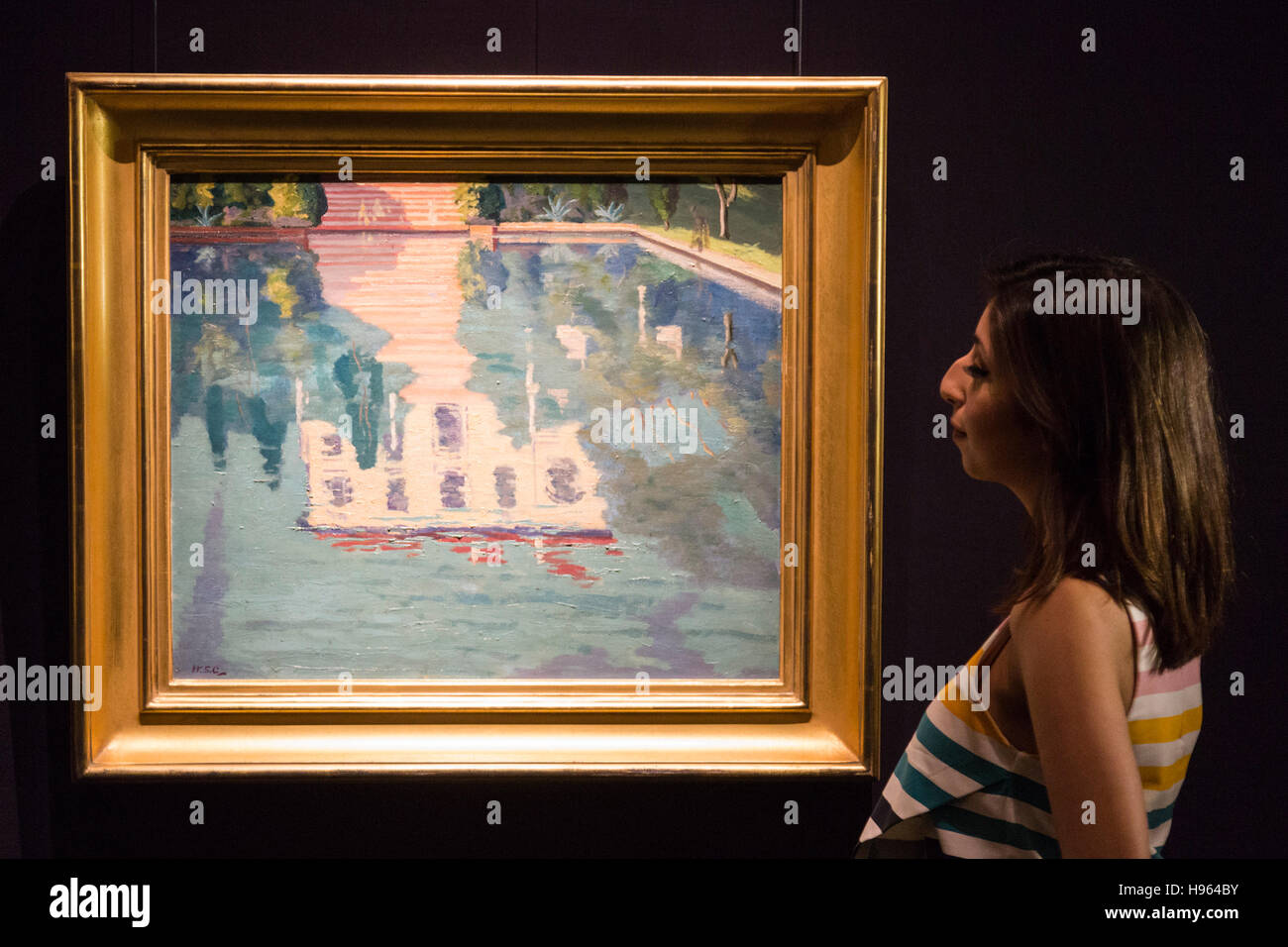 London, UK. 18 November 2016. A Sotheby's employee looks at the painting Les Zoraides on Cap Martin, 1935, by Sir Winston Churchill, est. GBP 100,000-150,000. Sotheby's presents a preview of Modern & Post-War British Art at their New Bond Street premises. The auction will take place on 22-23 November 2016 in London. Stock Photo