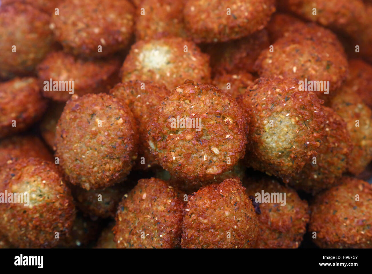 Traditional oriental Middle Eastern meal dish of deep fried ready to eat falafel balls on retail market display, close up Stock Photo