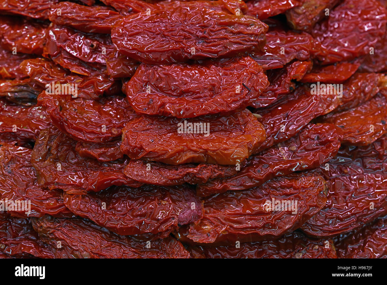 Sundried cured red tomatoes on retail fresh food market stall display, close up, high angle view Stock Photo