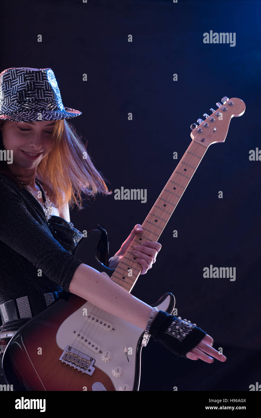 woman playing her guitar as a popstar caught in the action moment Stock  Photo - Alamy
