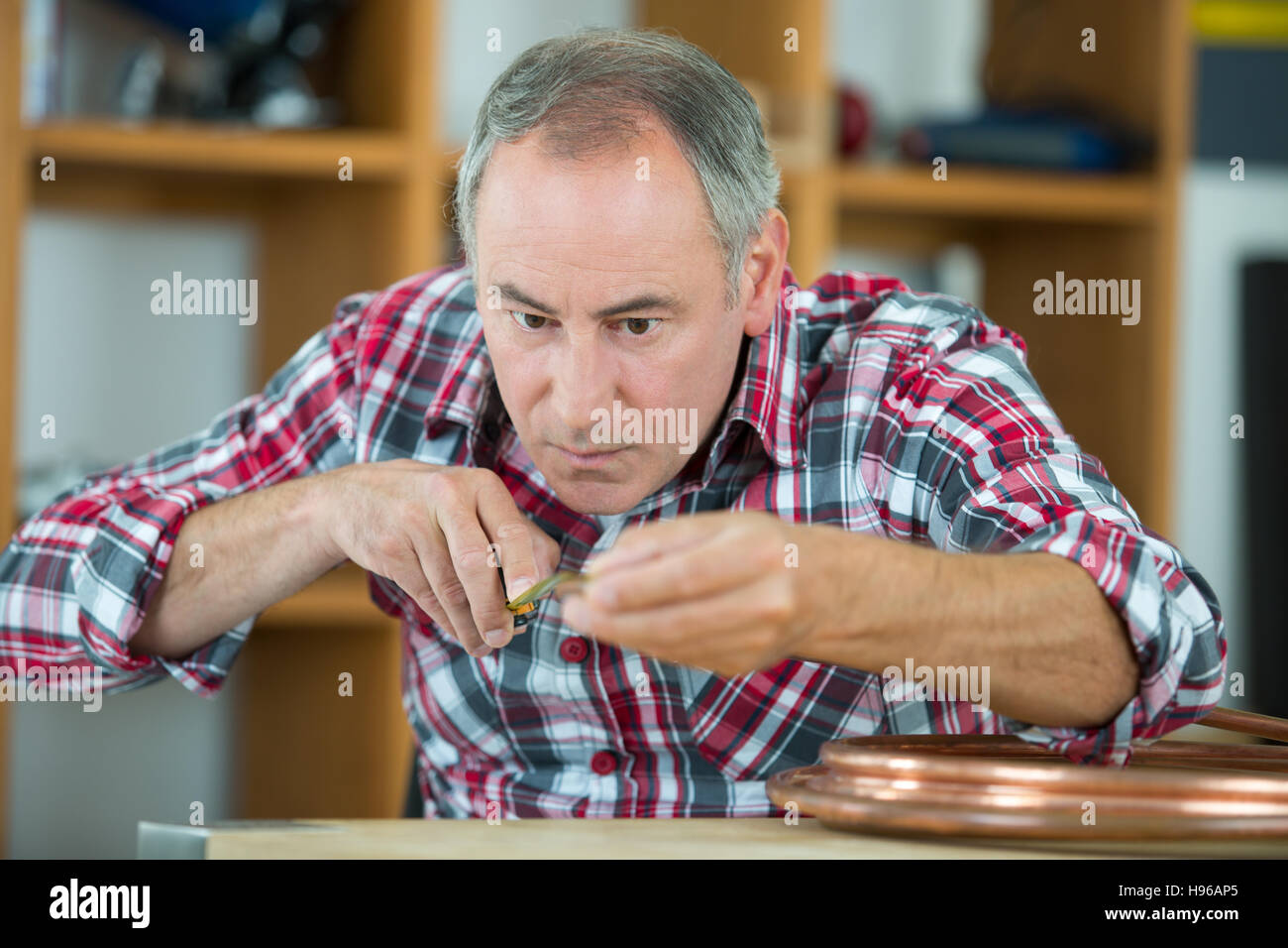 close up portrait of a middle-age watchmaker at work Stock Photo