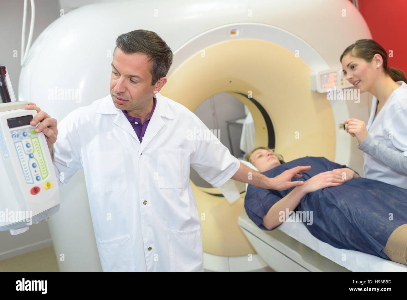 professional with patient and doctor using cat scan Stock Photo