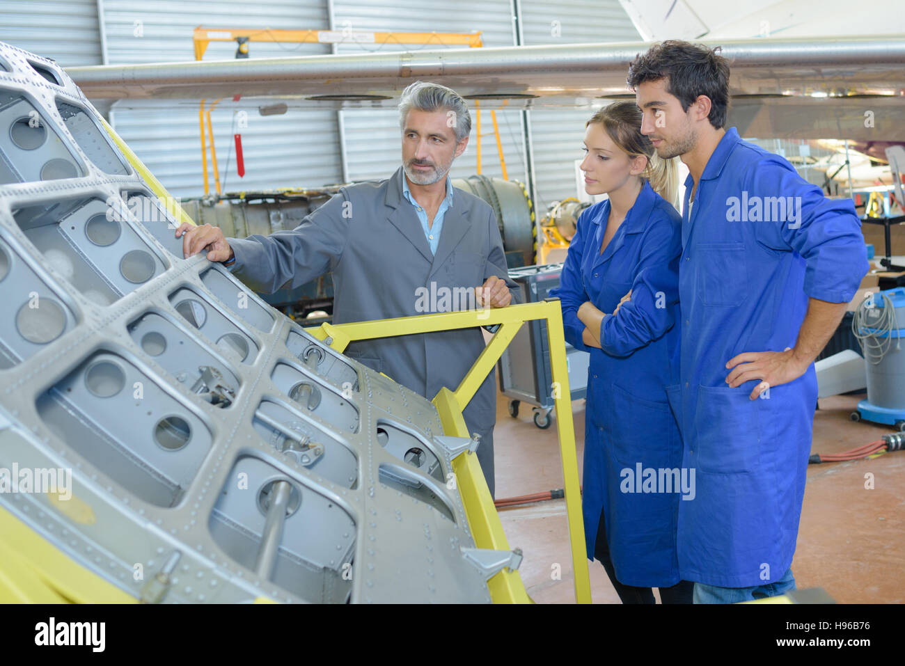 apprentices with professional metallurgist Stock Photo