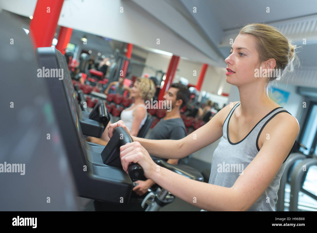 fit blonde using the step machine at the gym Stock Photo Alamy