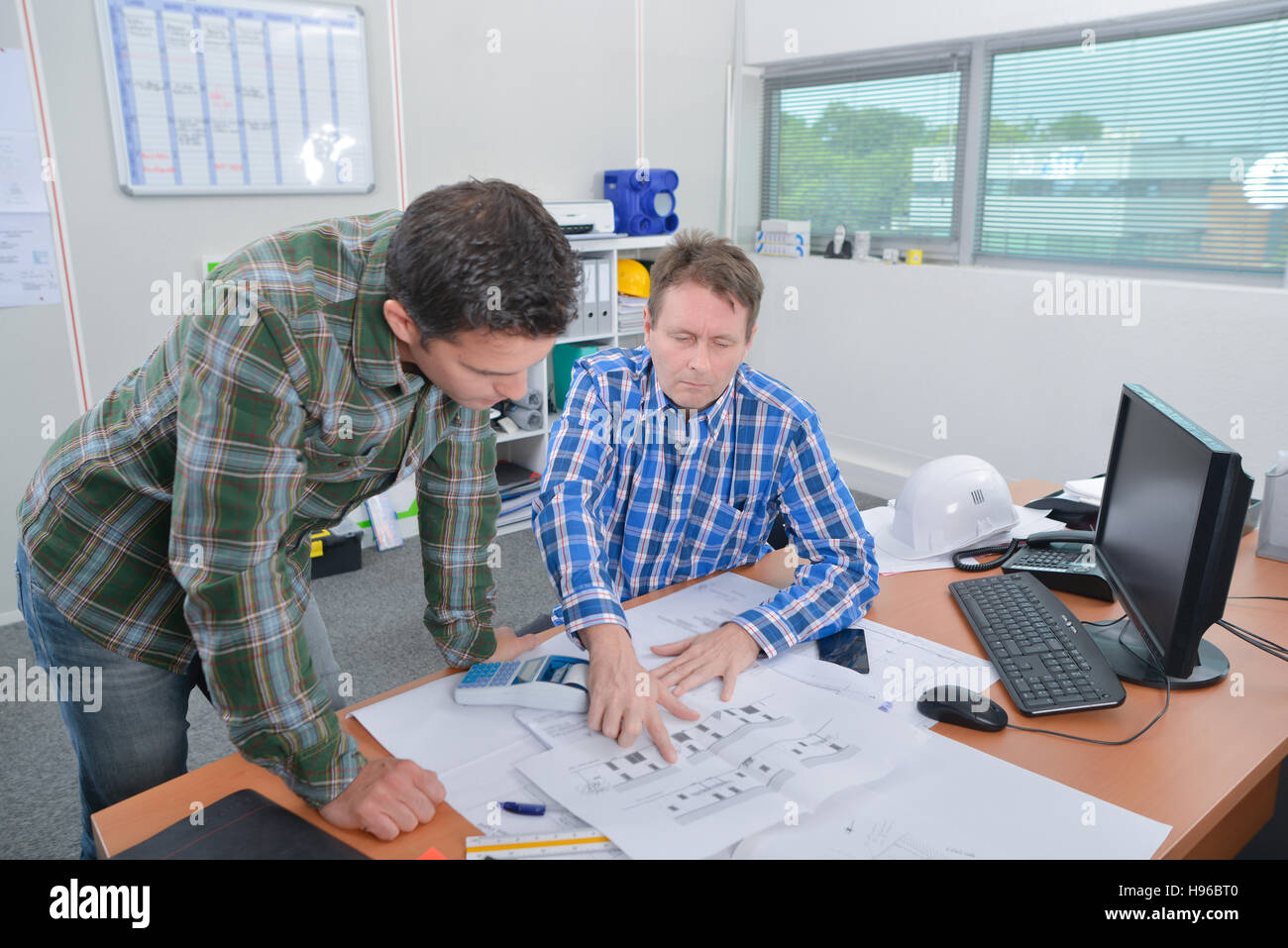 Architect explaning something to client Stock Photo - Alamy