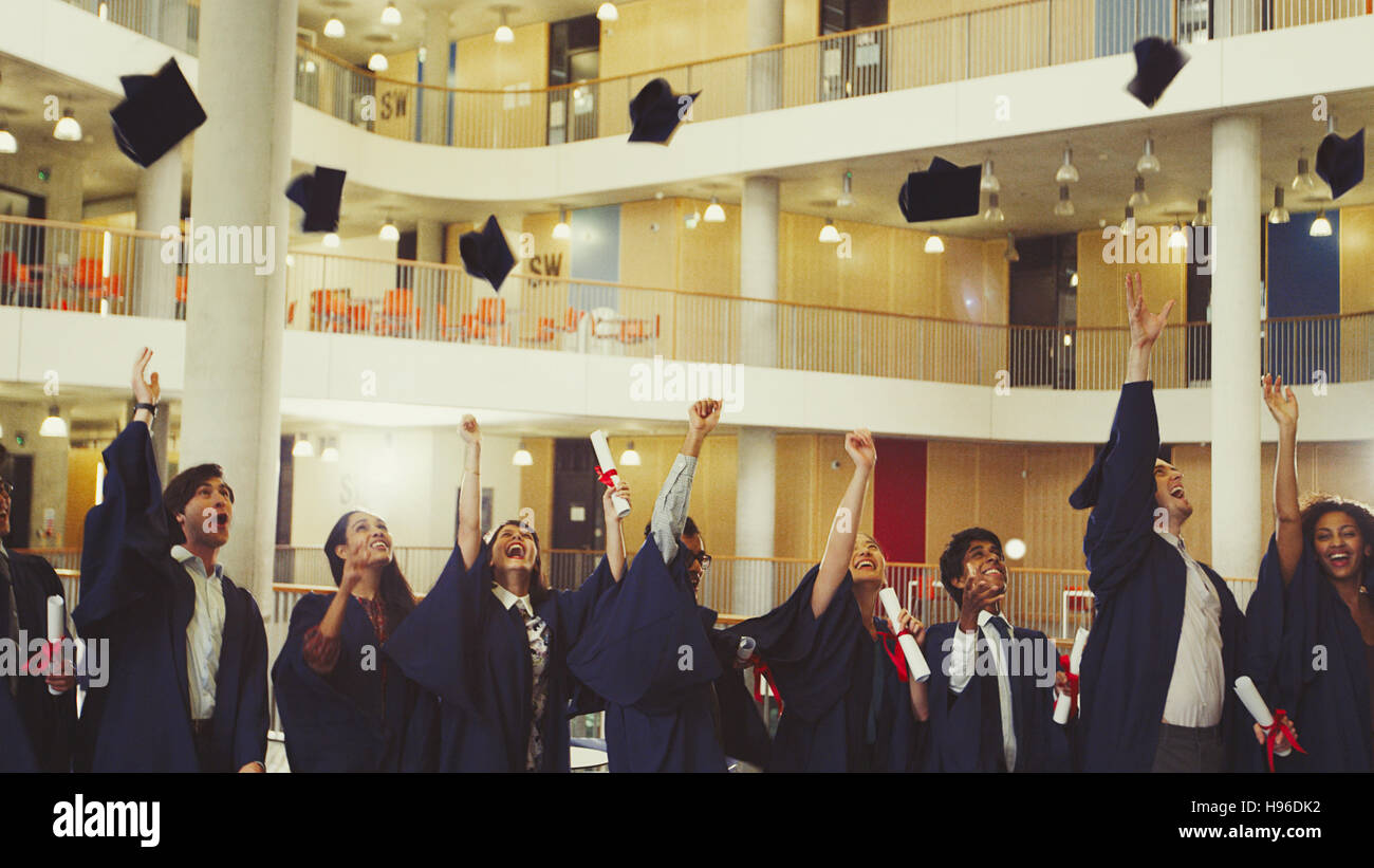 College graduates throwing cap Stock Photo