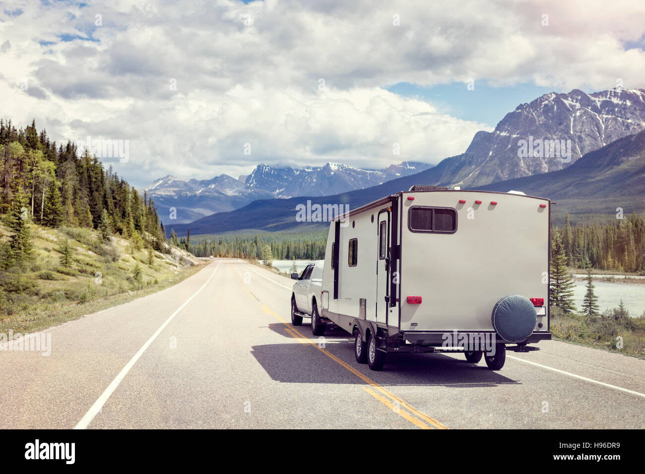 Caravan or recreational vehicle motor home trailer on a mountain road in Canada Stock Photo
