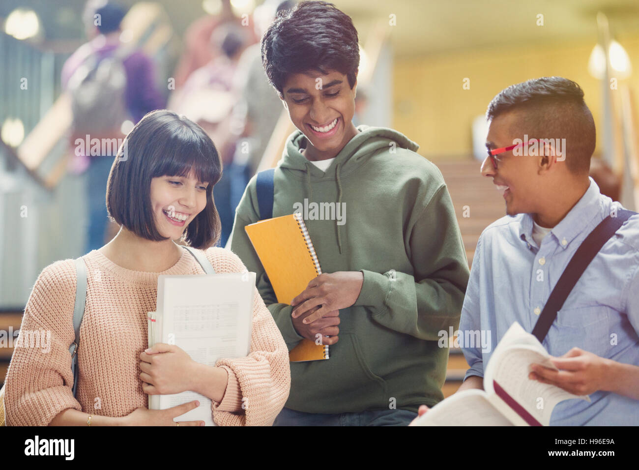 College students discussing homework in stairway Stock Photo