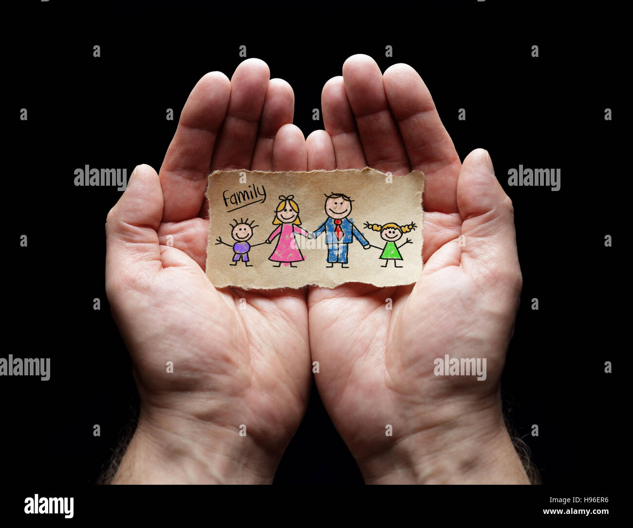Family care with the protection of cupped hands, concept for love, help, assistance, security and caring Stock Photo