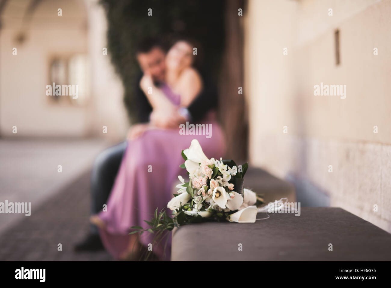 Wedding flowers bouquet with newlywed couple on background Stock Photo ...