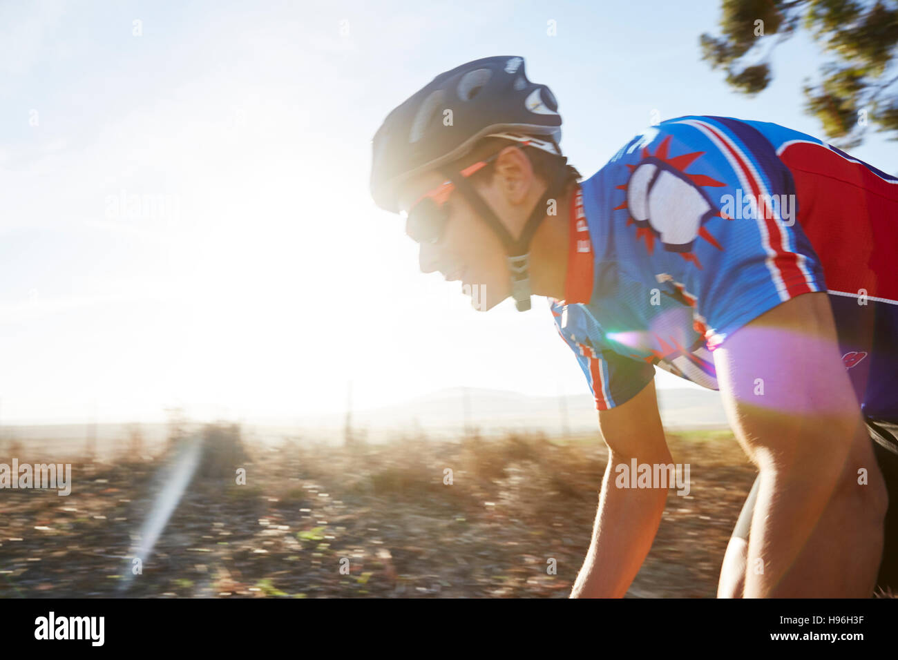 Male triathlete cyclist cycling at sunrise Stock Photo Alamy