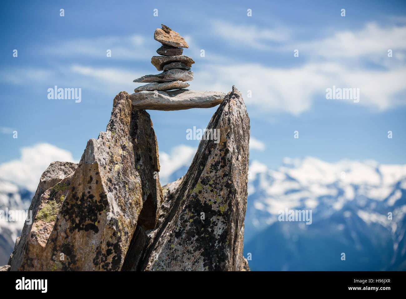 Stones cairn bridging gap near Eggishorn peak, Alps, Switzerland Stock Photo