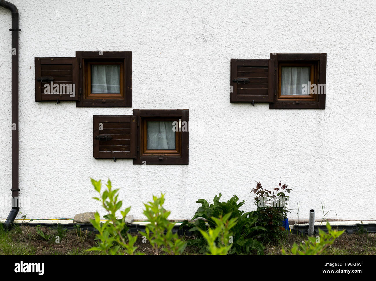 Three windows on a white wall Stock Photo - Alamy