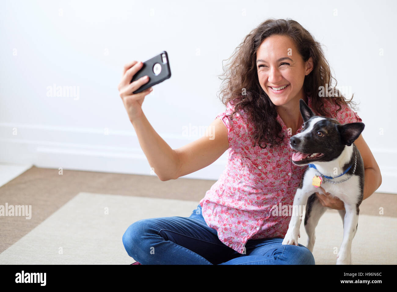 Young woman taking selfie with her dog Stock Photo - Alamy