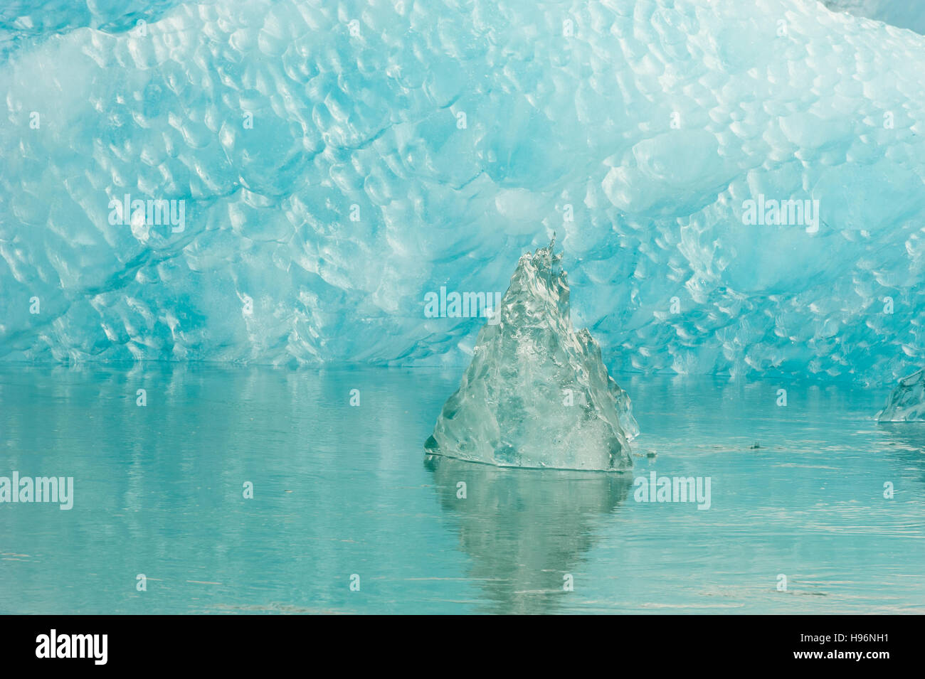 Carbon footprint on nature, climate emergency, climate crisis, climate change effect impact, an ice block surrounded by clear ice in flowing water Stock Photo