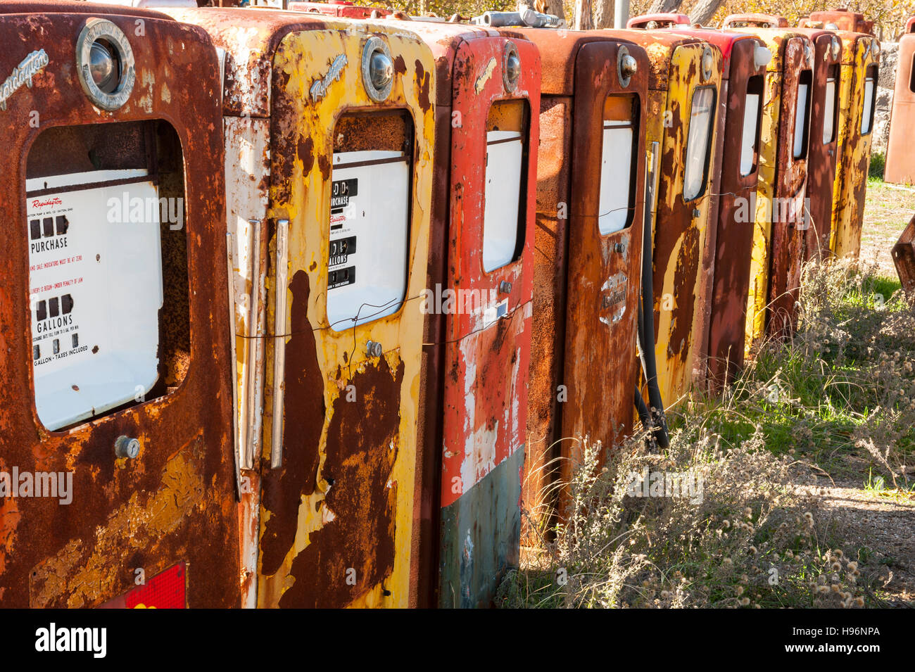 Old fuel pump, a group of several old and rusty abandoned multicolored fuel pumps Stock Photo