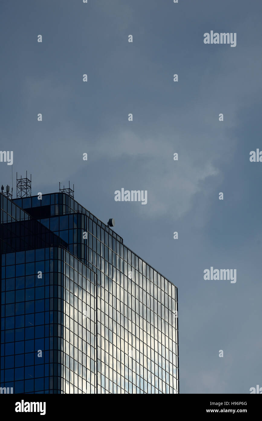 USA, Boston, Massachusetts, Glass office building and cloudy sky Stock Photo
