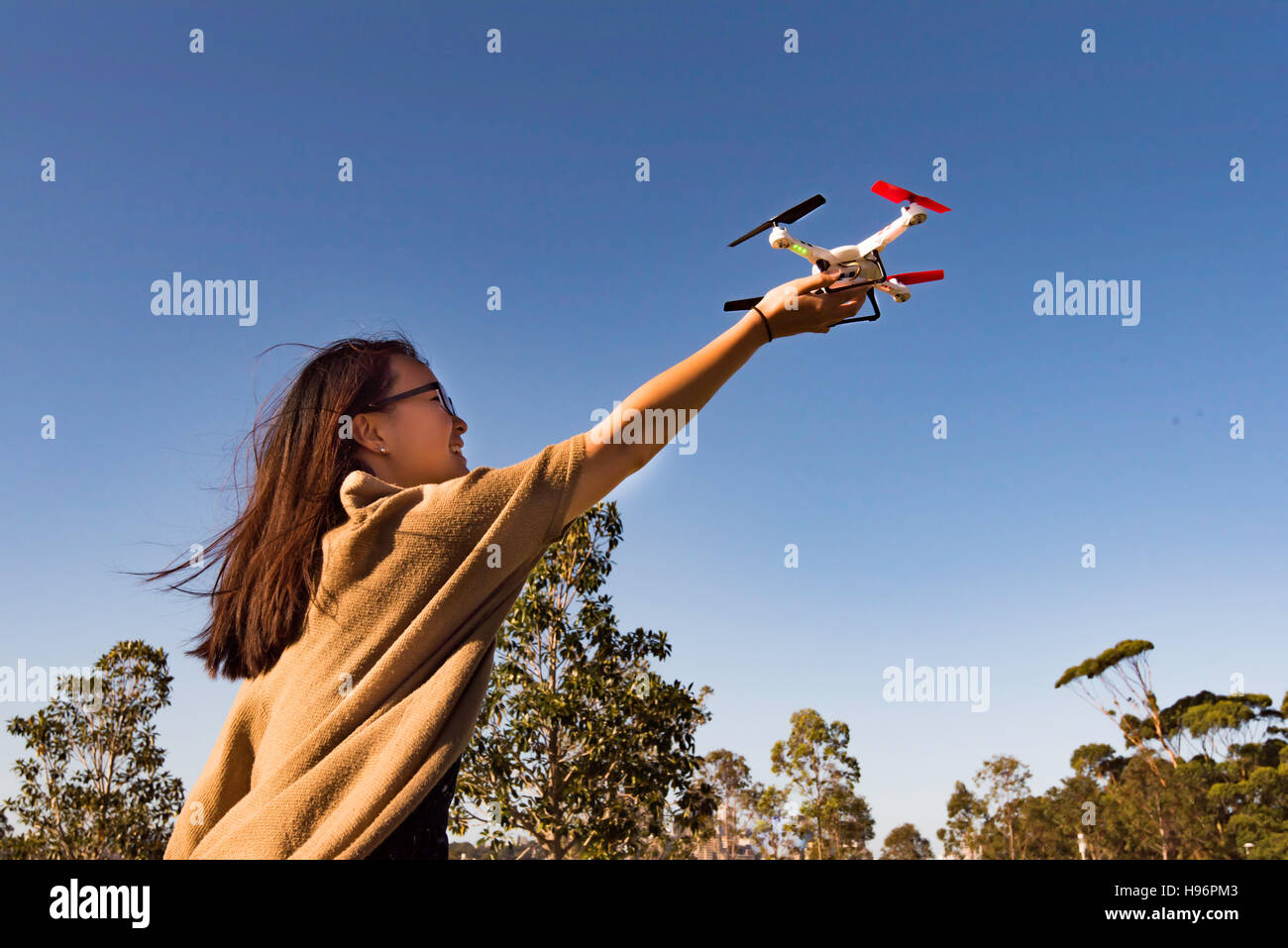 Two people in a Sydney park playing with a drone Stock Photo