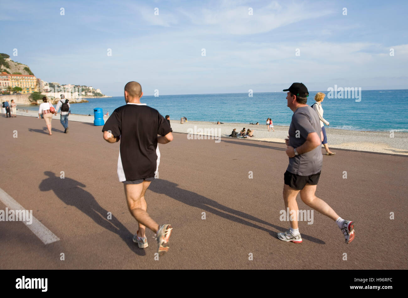 Men jogging on Promenade des Anglais, beach, Nice, Cote d'Azur, France