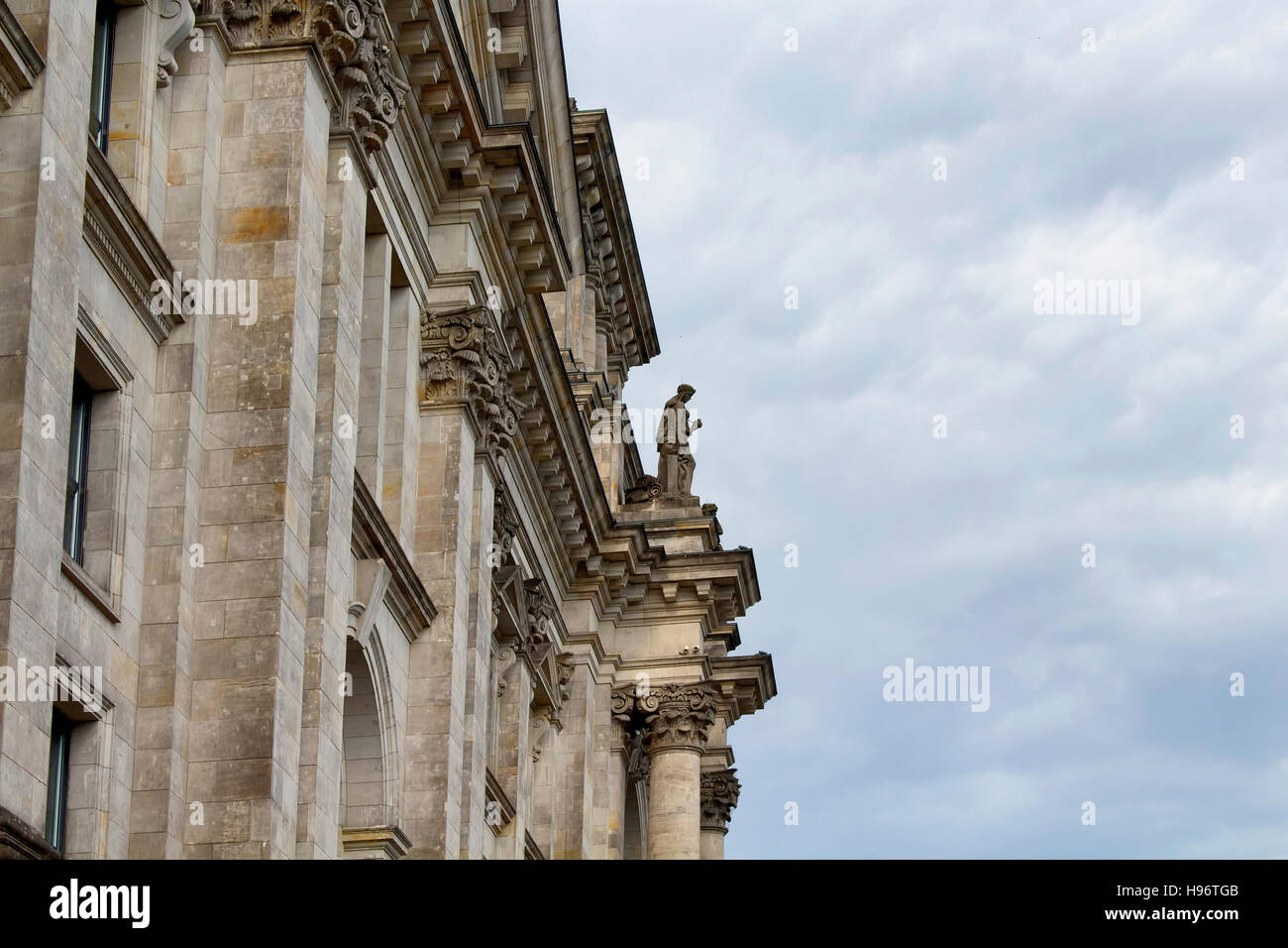 Side view of Reichstag building with cloudy sky background. Neo-Renaissance parliament house topped by a Norman Foster glass dome with 360-degree city Stock Photo