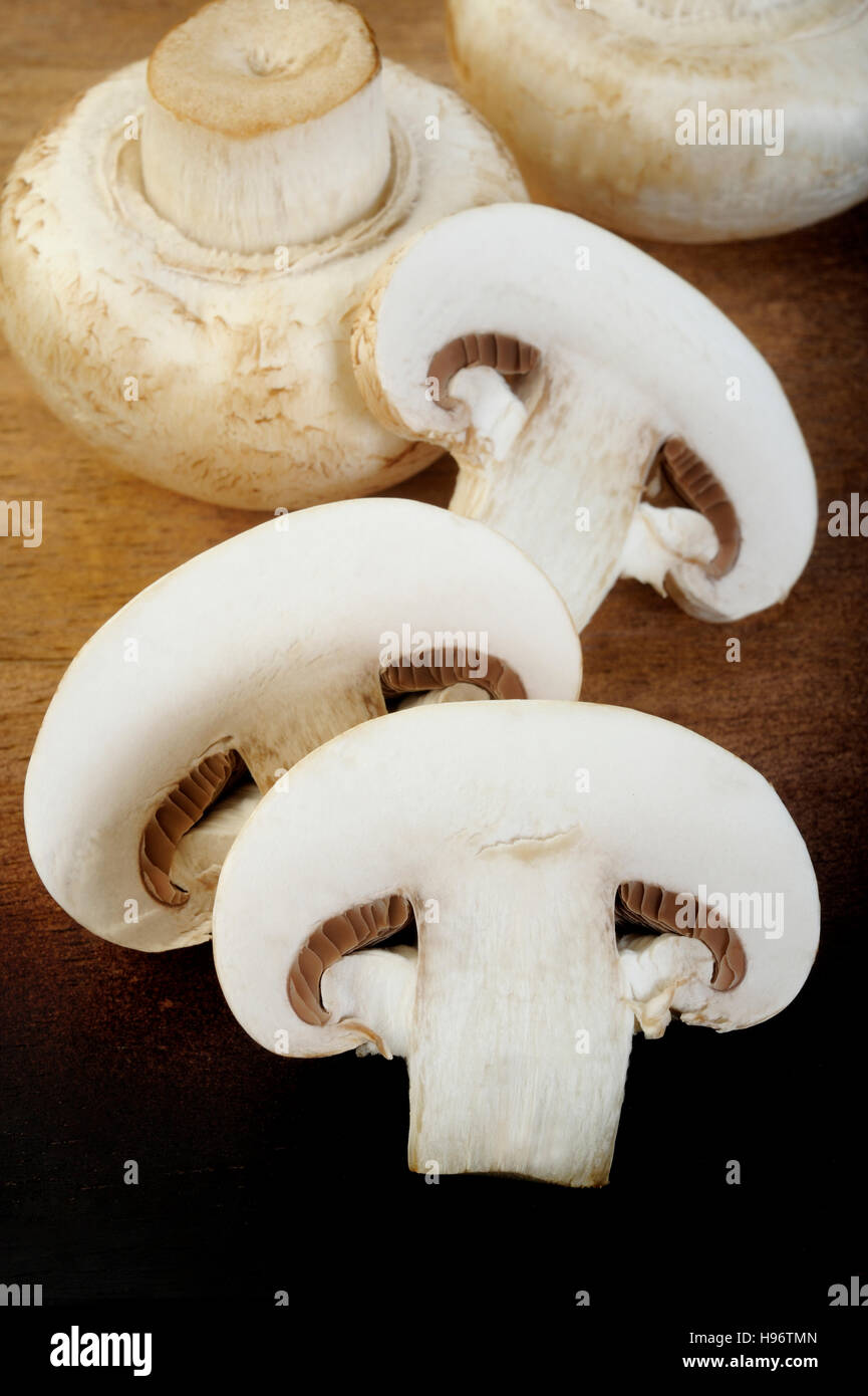 fresh champignon mushrooms on wooden background Stock Photo